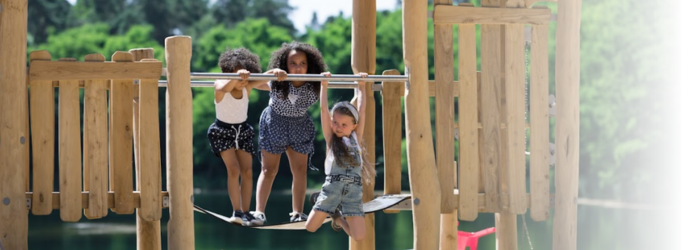 Children playing on robinia playground equipment