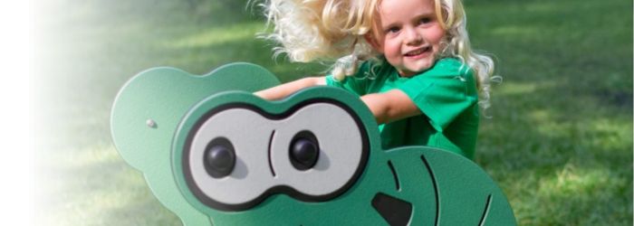 Photo of child playing on recycled playground equipment