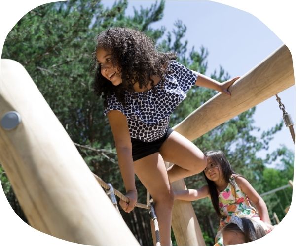 A child playing on wooden playground equipment