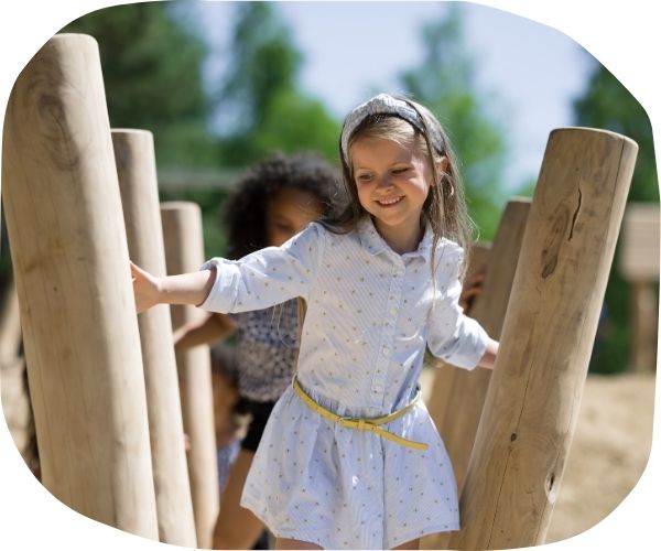 Child traversing across playground equipment